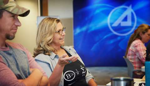 Teachers interact with Aerospace employees at a workshop in Albuquerque